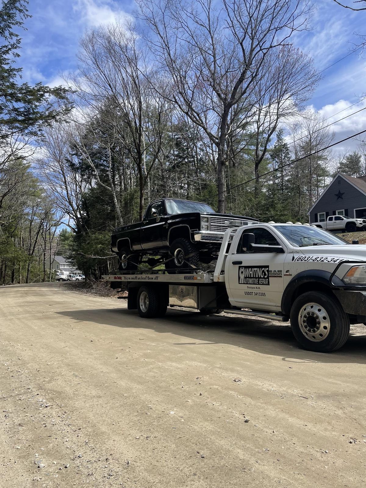 Whiting's flatbed hauling a lifted classic Chevy pickup
