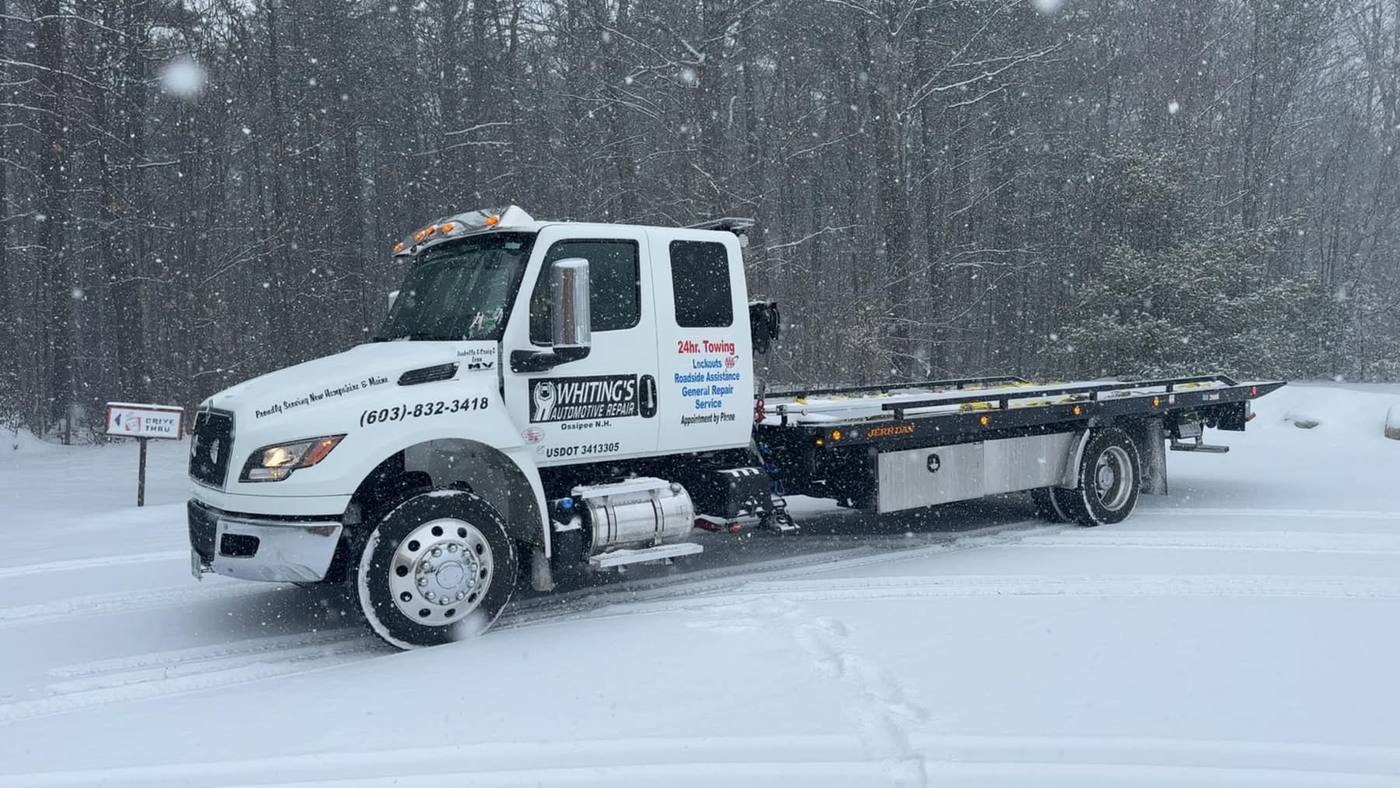 Flatbed tow truck in snowstorm