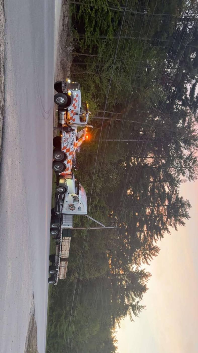 Flatbed tow truck in parking lot