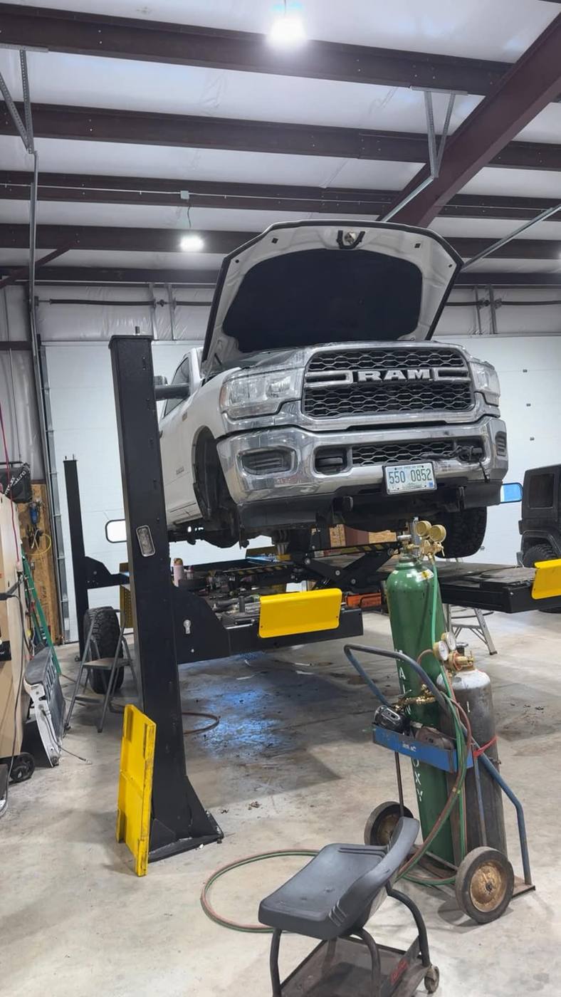 Wheel-lift tow truck loading a car in Ossipee, NH